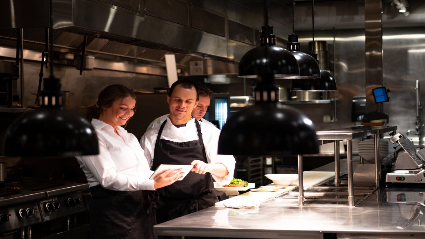 Hospitality team discussing bookings on a tablet